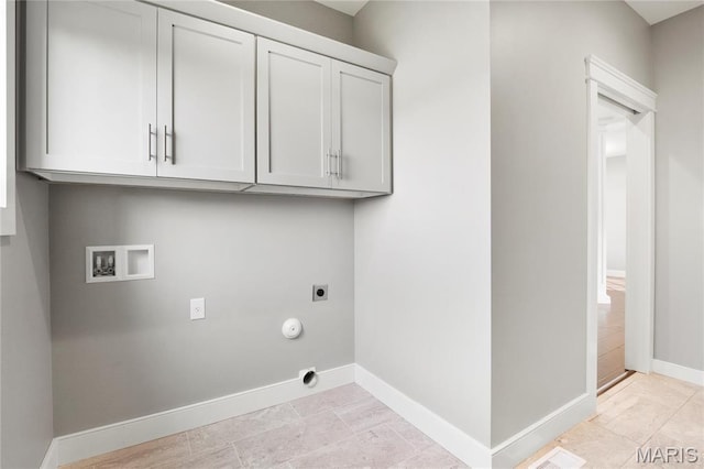 laundry area with hookup for an electric dryer, washer hookup, cabinet space, baseboards, and gas dryer hookup