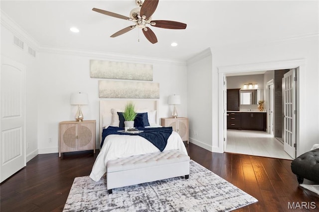 bedroom featuring crown molding, wood-type flooring, baseboards, ensuite bath, and ceiling fan