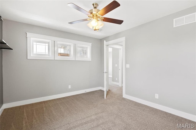 unfurnished bedroom featuring carpet floors, baseboards, and ceiling fan