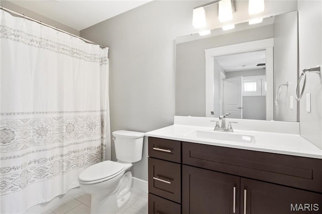 bathroom with toilet, vanity, tile patterned flooring, and curtained shower