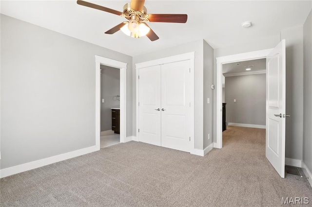 unfurnished bedroom with light carpet, baseboards, a closet, and ceiling fan
