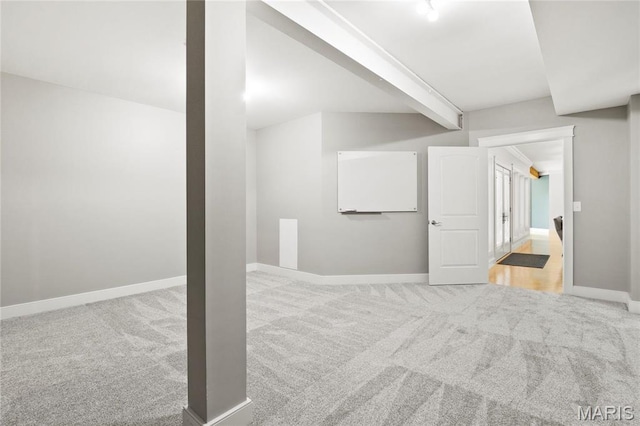 basement featuring carpet flooring and baseboards
