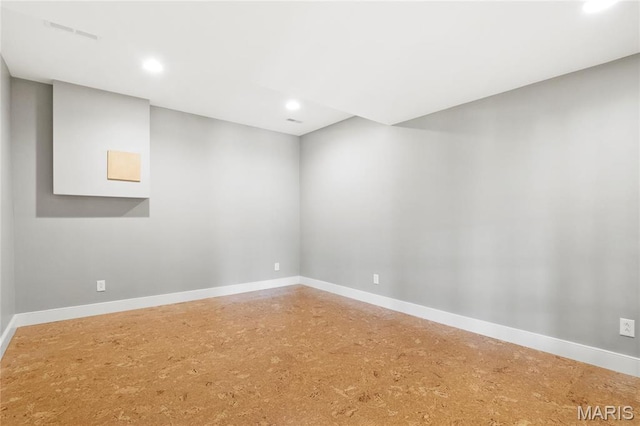 unfurnished room with baseboards and recessed lighting