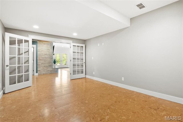 empty room with french doors, baseboards, and recessed lighting
