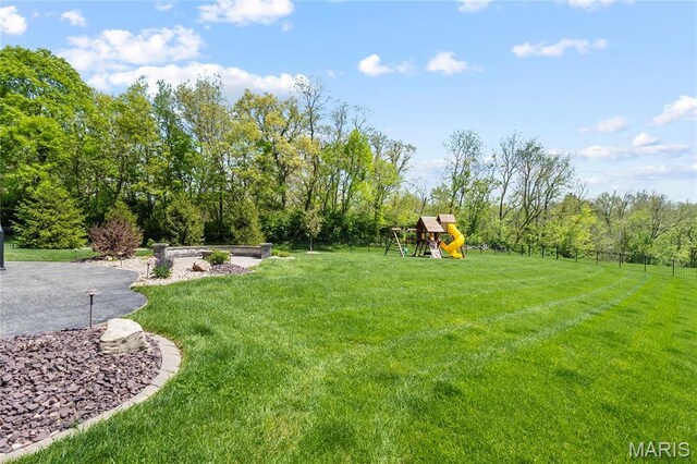 view of grassy yard with a playground
