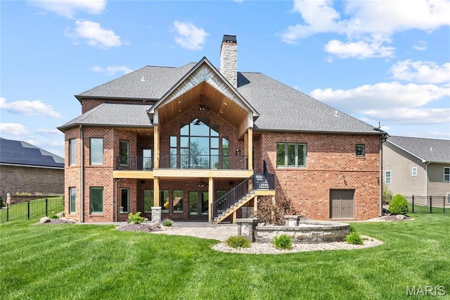 rear view of house featuring brick siding, a patio area, roof with shingles, a chimney, and stairs