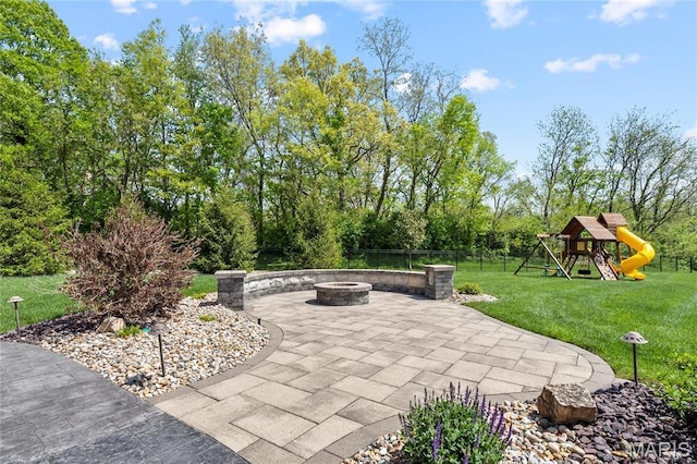 view of patio / terrace with a fire pit and a playground