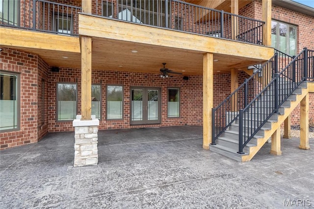 view of patio featuring french doors, stairs, and a ceiling fan