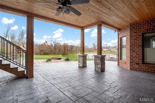 view of patio / terrace with stairs and a ceiling fan
