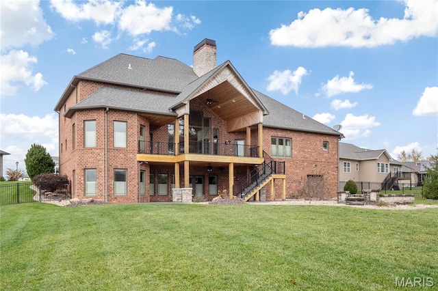 back of house with stairs, brick siding, a chimney, and a fire pit