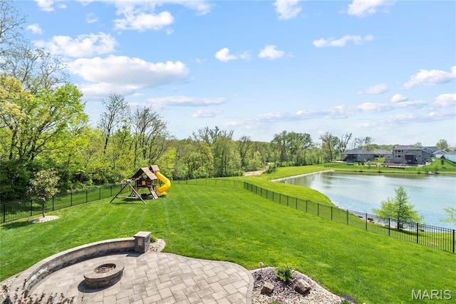 view of yard with an outdoor fire pit, a water view, a patio, and a playground