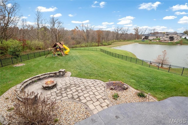 view of yard featuring a water view, a patio area, a playground, and a fire pit