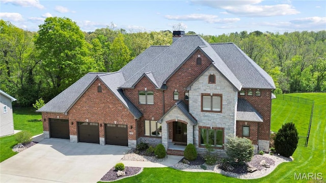 view of front facade featuring stone siding, a front lawn, and concrete driveway