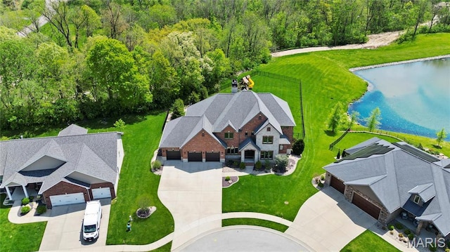 view of subject property with a nearby body of water and a heavily wooded area
