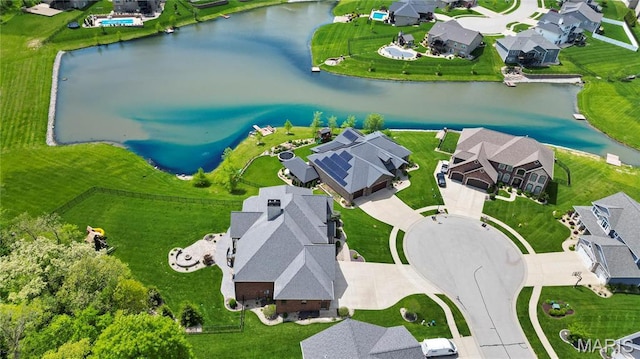 aerial view of residential area featuring a nearby body of water