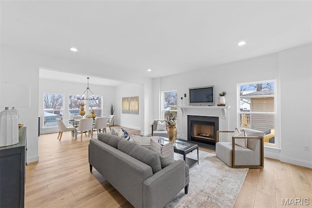119 Monica Dr, Sunset Hills, MO 63127 - living area featuring light wood-style floors, a fireplace, recessed lighting, baseboards, and a chandelier
