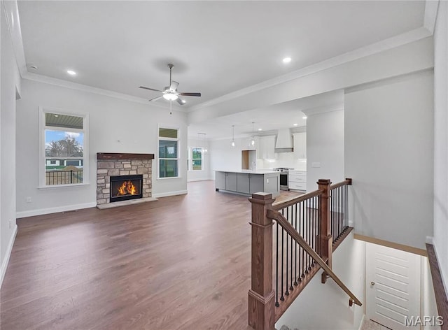 130 Stone Canyon Blvd, Foristell, MO 63348 - living area with baseboards, wood finished floors, crown molding, ceiling fan, and a fireplace