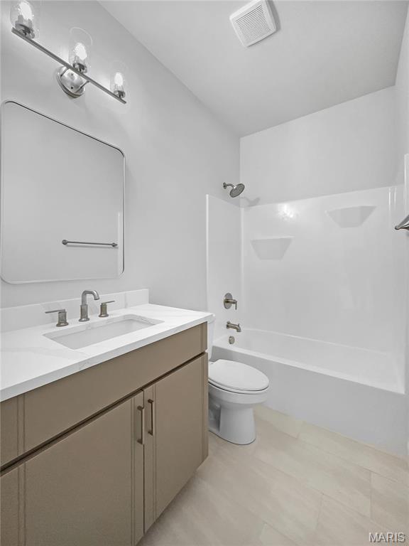 130 Stone Canyon Blvd, Foristell, MO 63348 - full bathroom featuring toilet, vanity, and washtub / shower combination