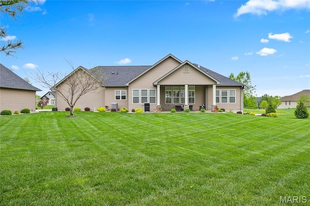 132 Hillary Cir, Wentzville, MO 63385 - back of house with a lawn, a shingled roof, and cooling unit