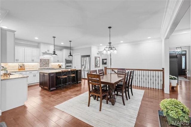 132 Hillary Cir, Wentzville, MO 63385 - dining room with recessed lighting, a chandelier, wood-type flooring, and crown molding