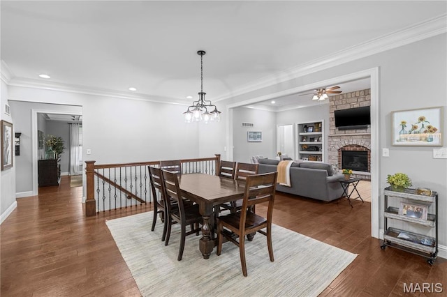 132 Hillary Cir, Wentzville, MO 63385 - dining room featuring a stone fireplace, recessed lighting, a ceiling fan, wood finished floors, and ornamental molding