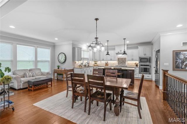 132 Hillary Cir, Wentzville, MO 63385 - dining room featuring hardwood / wood-style floors, recessed lighting, crown molding, and a chandelier