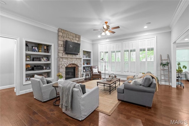 132 Hillary Cir, Wentzville, MO 63385 - living room featuring a stone fireplace, crown molding, healthy amount of natural light, dark wood finished floors, and recessed lighting