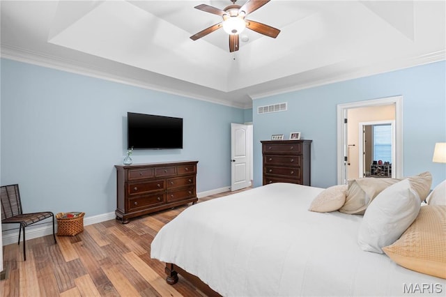 132 Hillary Cir, Wentzville, MO 63385 - bedroom with a tray ceiling, wood finished floors, baseboards, crown molding, and a ceiling fan