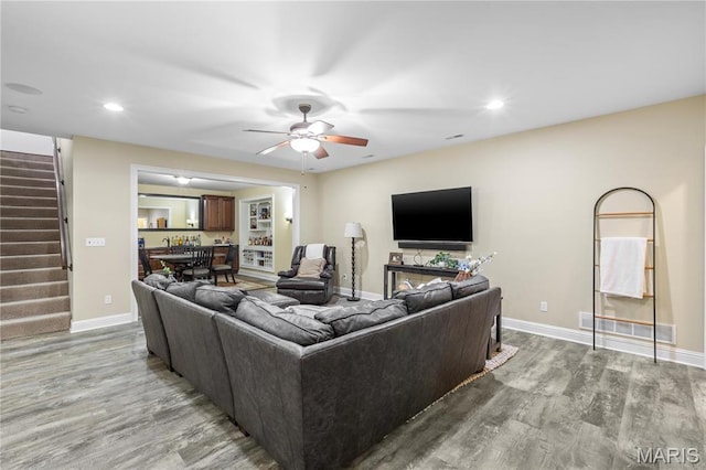 132 Hillary Cir, Wentzville, MO 63385 - living room with light wood-style floors, stairway, a ceiling fan, baseboards, and recessed lighting