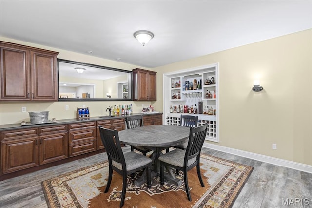132 Hillary Cir, Wentzville, MO 63385 - dining space with wood finished floors, bar, and baseboards