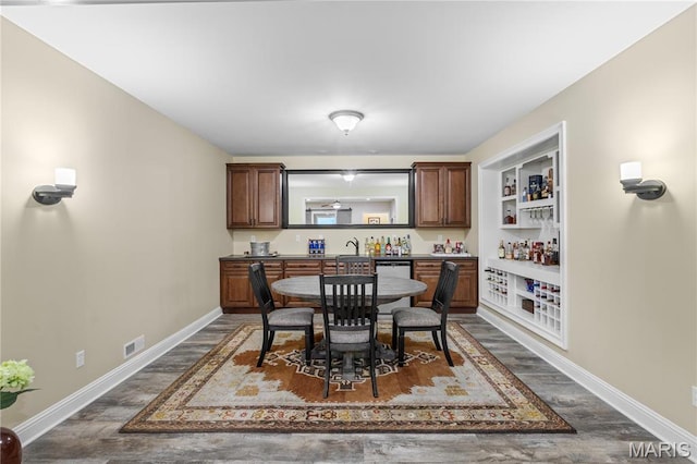 132 Hillary Cir, Wentzville, MO 63385 - dining space featuring wet bar, baseboards, and dark wood finished floors