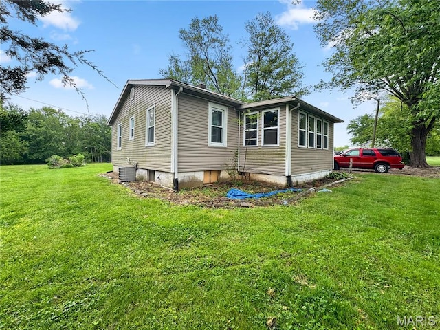 view of home's exterior featuring a lawn and central air condition unit