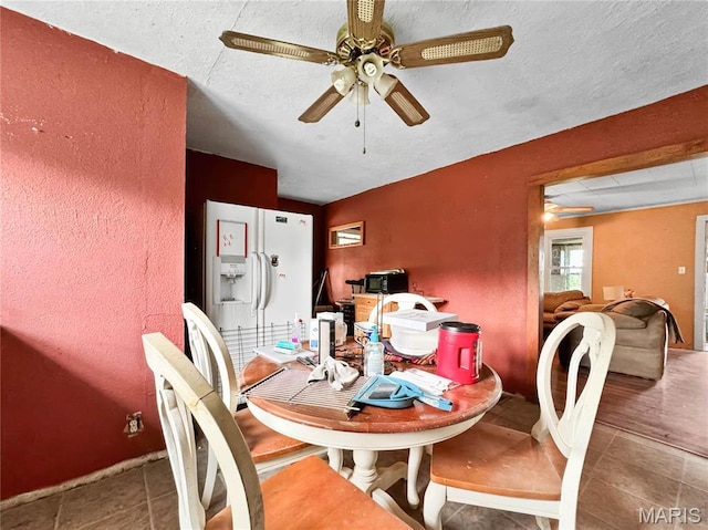 dining room featuring a ceiling fan and tile patterned floors