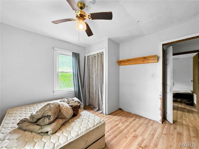 bedroom with light wood-type flooring and a ceiling fan