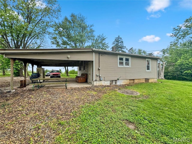 view of side of home featuring a lawn and a carport