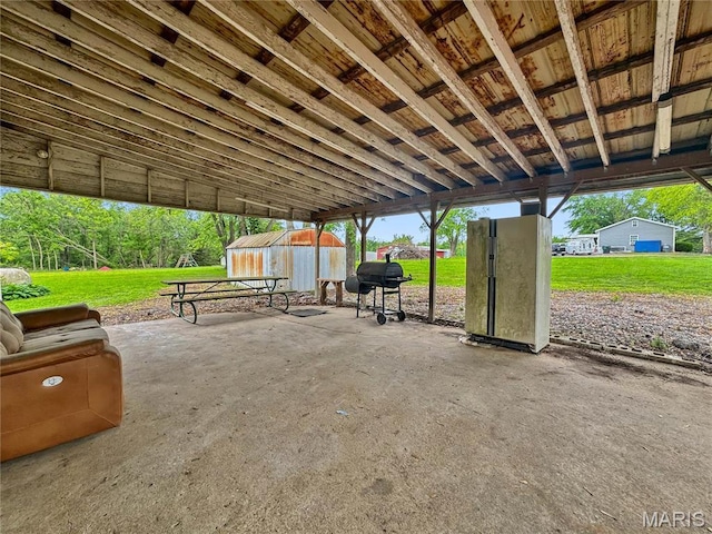 view of patio / terrace featuring grilling area and an outbuilding