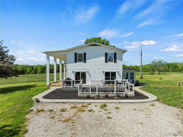 back of house featuring a yard and a deck