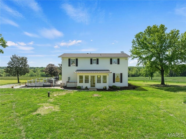 back of property with a lawn
