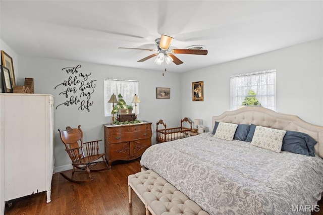 bedroom featuring multiple windows, wood finished floors, ceiling fan, and baseboards