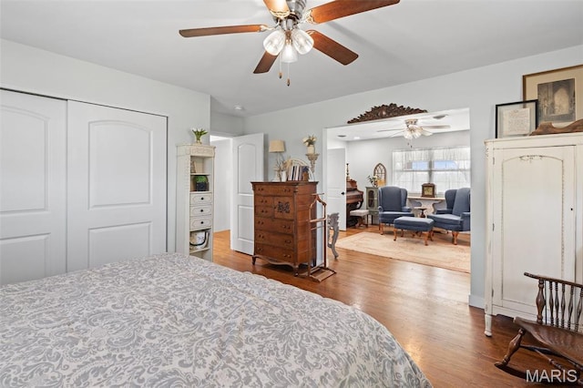 bedroom with wood finished floors, a closet, and a ceiling fan
