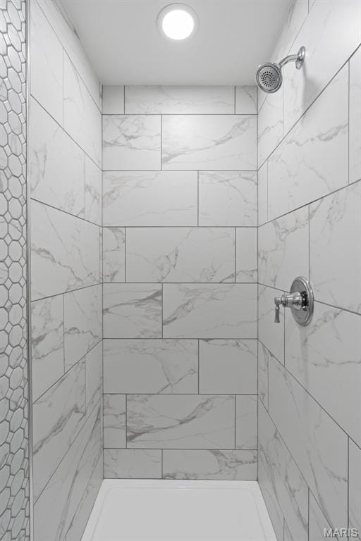 full bathroom with tiled shower