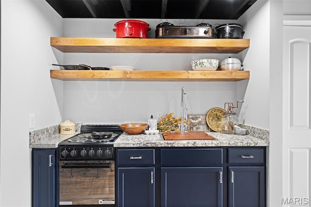 bar area featuring black gas stove and a sink
