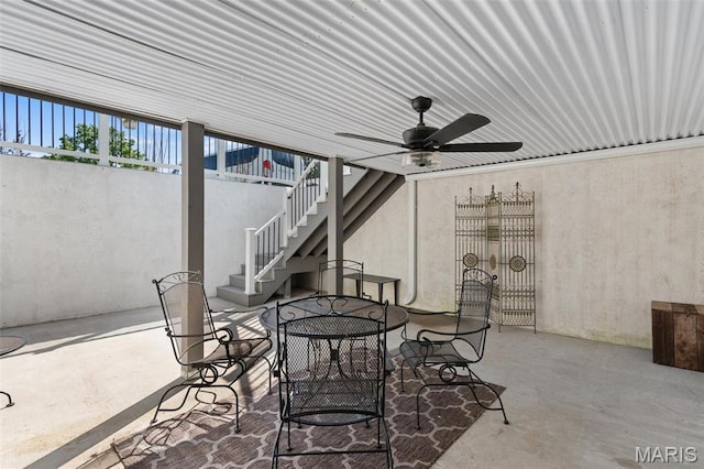 view of patio with stairs, ceiling fan, and outdoor dining area