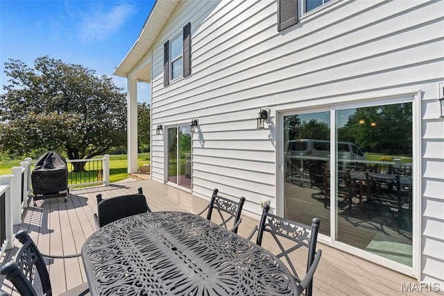 deck with outdoor dining area