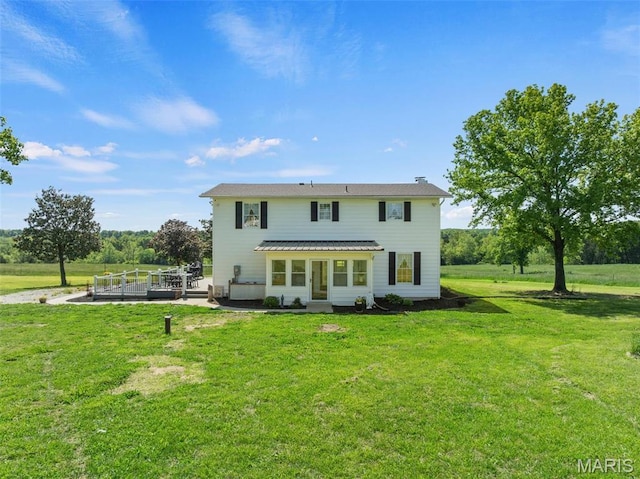 back of house with a lawn