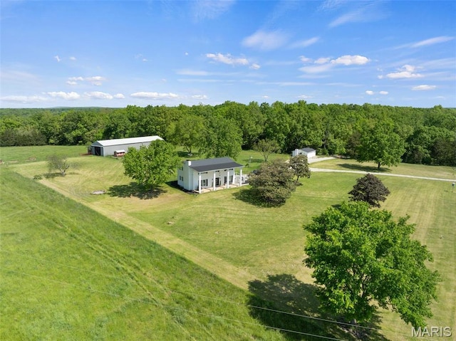 aerial view of sparsely populated area with a heavily wooded area