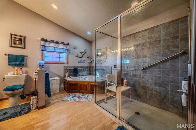 23598 Falcon Rd, Lebanon, MO 65536 - bathroom with vaulted ceiling, a stall shower, wood finished floors, a garden tub, and toilet