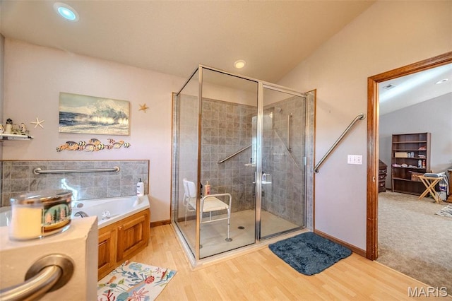 23598 Falcon Rd, Lebanon, MO 65536 - bathroom featuring wood finished floors, a stall shower, a bath, baseboards, and vaulted ceiling