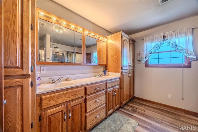 23598 Falcon Rd, Lebanon, MO 65536 - bathroom with double vanity, wood finished floors, and baseboards