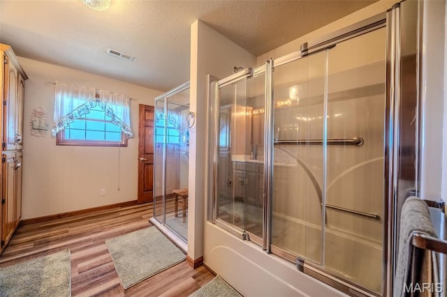 23598 Falcon Rd, Lebanon, MO 65536 - full bath featuring wood finished floors, baseboards, and a textured ceiling
